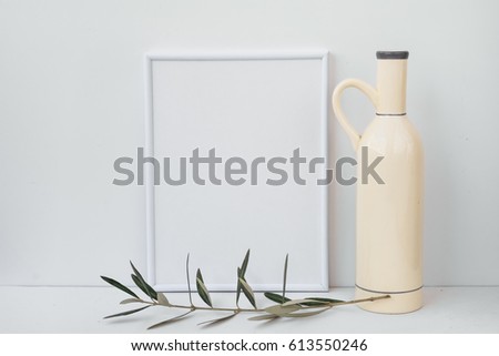 Frame mockup on white background, ceramic bottle, olive tree branch, clean minimalist styled image for social image, marketing, blogging