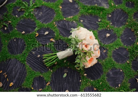wedding bouquet on a green grass and logs