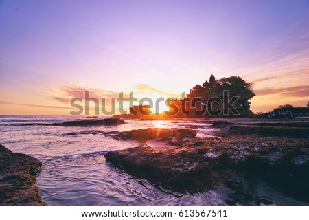 Beautiful balinese landscape. Ancient hinduism temple Tanah lot on the rock against sunset sky. Bali Island, Indonesia. Royalty-Free Stock Photo #613567541