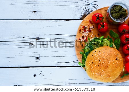 Close up of gluten free vegan sandwiches made with pesto sauce, cucumber, basil and sprouts on white wooden background. Top view. Flat lay style.