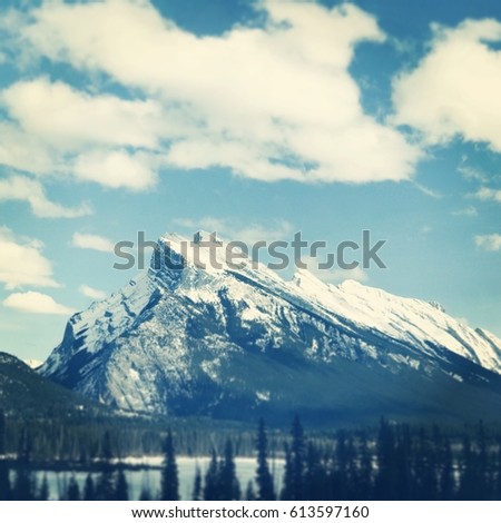 Beautiful mountains with clouds in sky and Instagram effect
