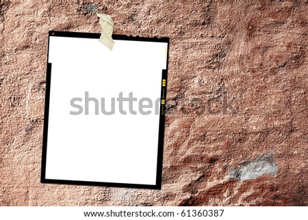 Printed large format film sheet, against grungy background, empty frame, free picture or copy space