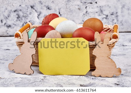 Easter basket, blank yellow card. Plywood rabbit cutouts. Easter party invitation.