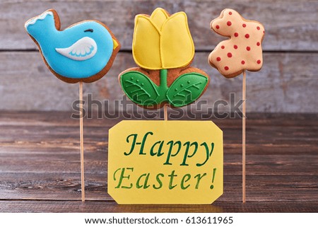Biscuits and Happy Easter card. Three cookies on sticks.
