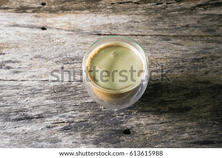Coffee cup on wooden table, top view
