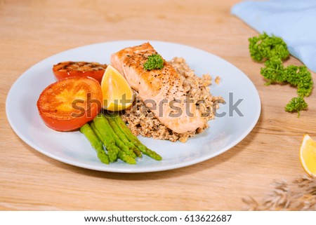 Delicious salmon steak , rich in omega 3 oil, with aromatic herbs and spices with a lemon.