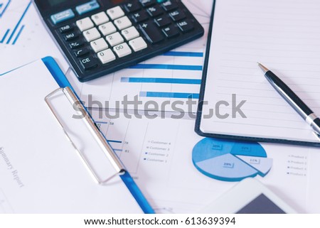 financial charts with graphs paper for Analyzing Statistic Chart On Paper put on the table at office.