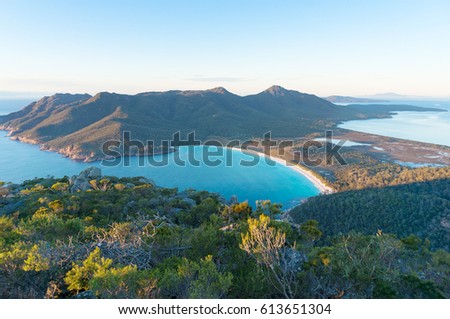 Aerial view of picturesque beach and mountains on sunny morning. Freycinet Park, Tasmania. Australia Royalty-Free Stock Photo #613651304