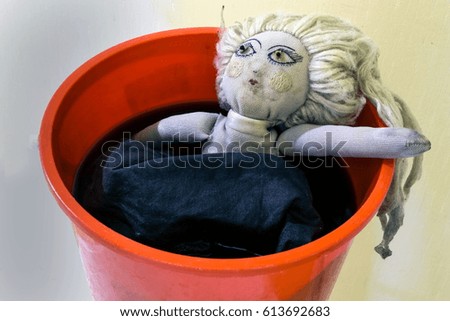 the dirty doll washes in a red bucket