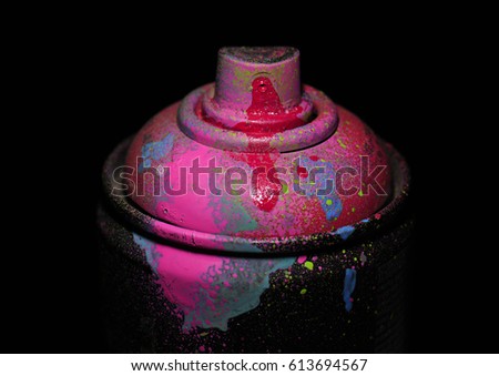 Aerosol paint on a dark background, pink color, dramatic lighting.