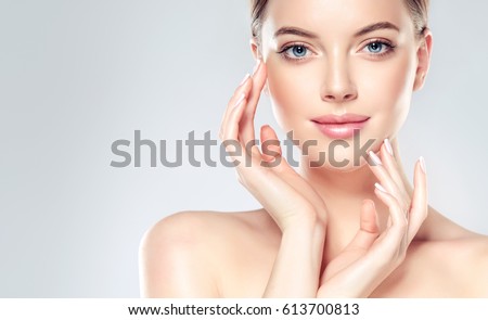 Beautiful Young Woman with Clean Fresh Skin look away  .Girl beauty face care. Facial  treatment   . Cosmetology , beauty  and spa . Royalty-Free Stock Photo #613700813