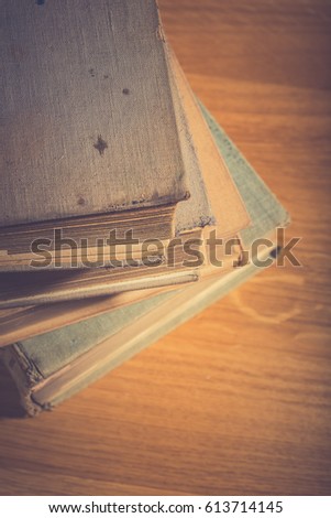 stack of old book on wooden table