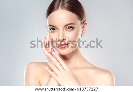 Beautiful Young Woman with Clean Fresh Skin look away  .Girl beauty face care. Facial  treatment   . Cosmetology , beauty  and spa . Royalty-Free Stock Photo #613737227
