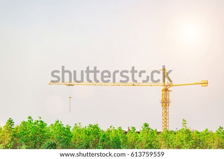 Crane and building construction site against in forest blue sky