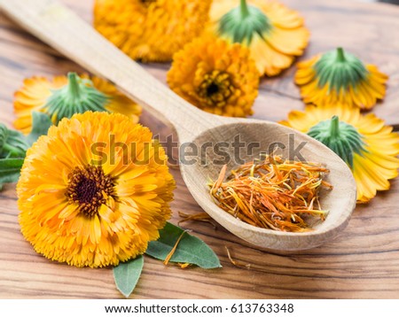 Calendula flowers on the old wooden table.