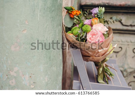 Colorful  bouquet of different fresh flowers on rustic background with copy space for text of advert