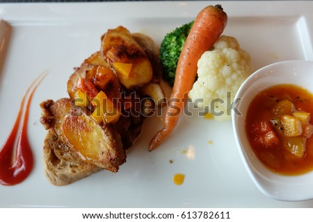 Mexican chicken breast with mango and dragon fruit sauce decorated with baby carrot, cauliflower and broccoli