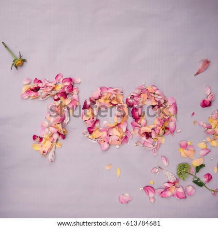 700 followers card.Template for social networks, blogs. Background with colorful flower petals