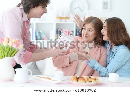 Adult children congratulate the elderly mother 