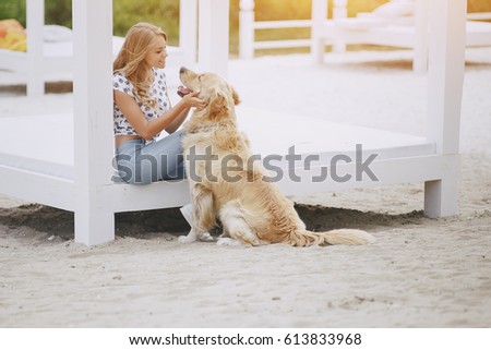 girl walking in the park with his dog girl playing with a dog at the beach and in the park
