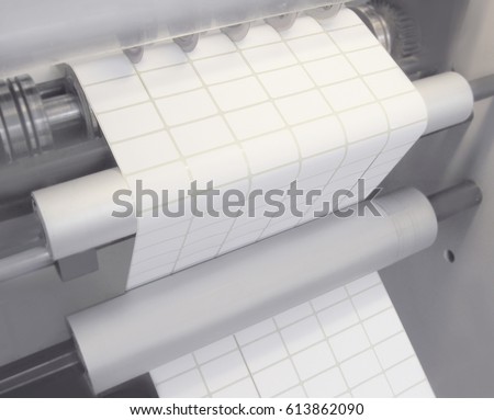 Photo production. Cutting labels on rolls.