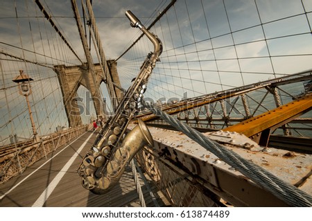 Old vintage alto saxophone with Brooklyn bridge in background