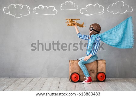 Child pretend to be pilot. Kid having fun at home. Summer vacation and travel concept Royalty-Free Stock Photo #613883483