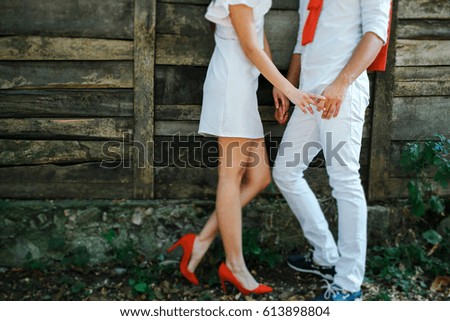 Bride and groom hold  hands life.
