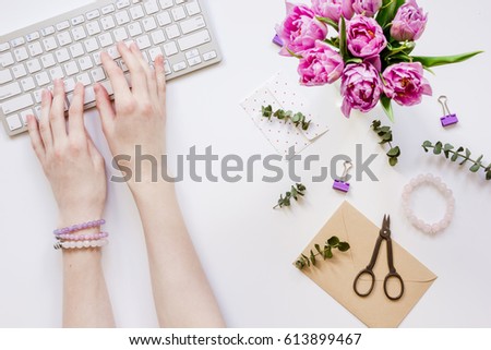 Spring flowers on workdesk at home white background top view