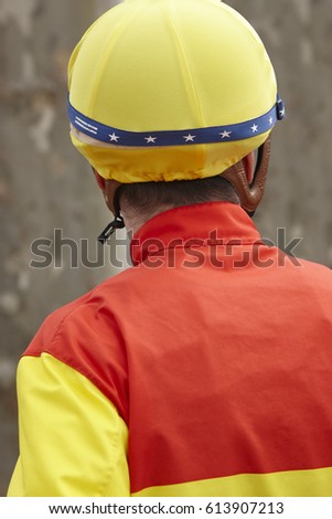 Jockey head detail before the race. Hippodrome background. Racehorse. Competition