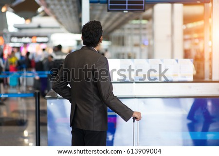 indian male checking airport schedule