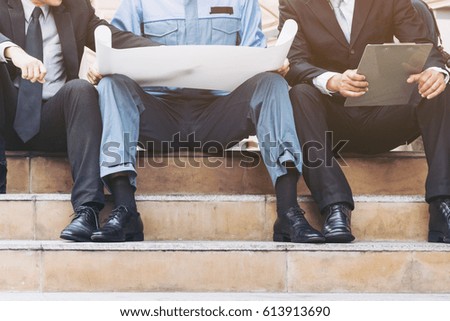 Engineer, architect, business man discuss on engineering blueprint drawing or architecture drawing.