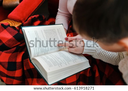 Mother and son reading a book at a photo shoot
