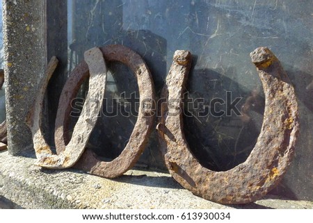 Brown rusty antique horseshoes in a barn