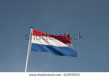 The Dutch red and white flag blowing in the wind