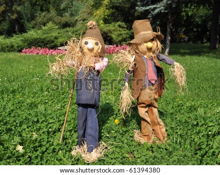 scarecrow couple on the green field