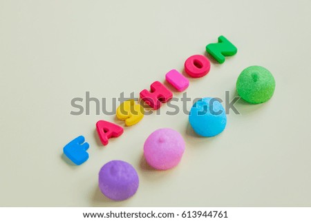 photo of tasty colorful marshmallows and colorful letters on the wonderful yellow background