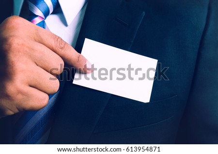 Close up of a man takes out blank business card from the pocket of his suit.
