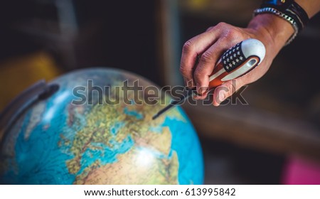 Globe Model And Hand Holding Screwdriver.
