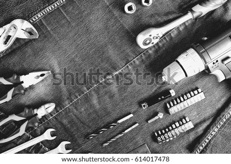 Jeans uniform and construction tools, top view
