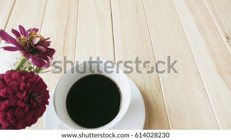 Coffee mug with bouquet of flowers on wooden table, beautiful breakfast, vintage card, Cross processing processed.