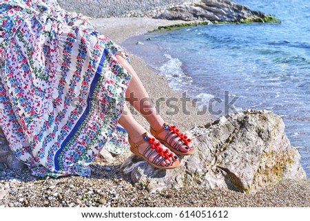 greek model advertises bohemian sandals on the beach 