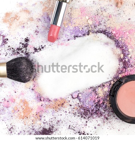 Makeup brush, lipstick, and powder on a white marble background, with traces of cosmetics forming a frame. A square template for a makeup artist's business card or flyer design, with copy space