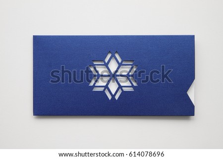 Greeting card design mock up, envelope from design paper with star or snowflake die-cut , isolated on white background, close up Royalty-Free Stock Photo #614078696