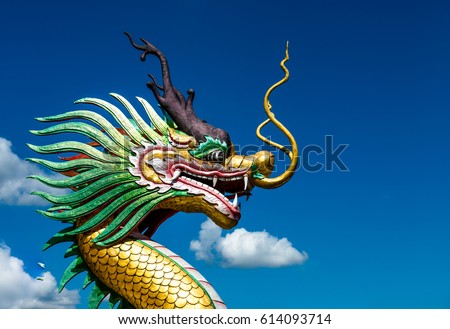 Multicolored Chinese dragon against blue sky, Beautiful dragon in chinese temple with blue sky,Thailand