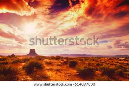 amazing landscape at the sunset at the monument valley national park in arizona USA with cloudy and drama sky Royalty-Free Stock Photo #614097830