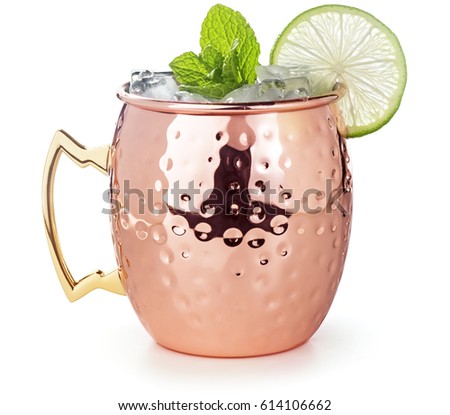 moscow mule cocktail in a copper mug garnished with lime and mint leaves Royalty-Free Stock Photo #614106662