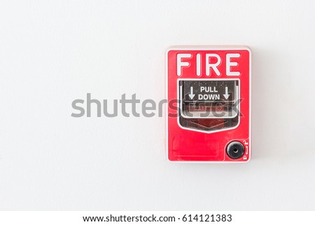 Fire alarm pull switch on the white wall with copy space and text.