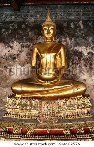 life size golden Buddha at a shrine in Bangkok Thailand 