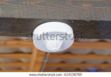 closeup of the motion sensor and smoke under the roof.